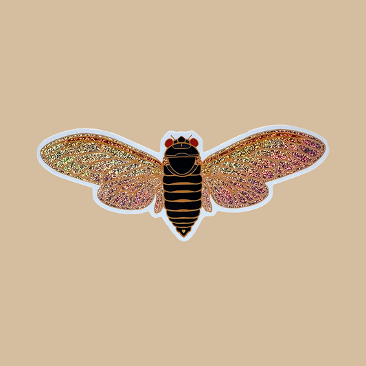 Insect-shaped object with glittery wings on a beige background