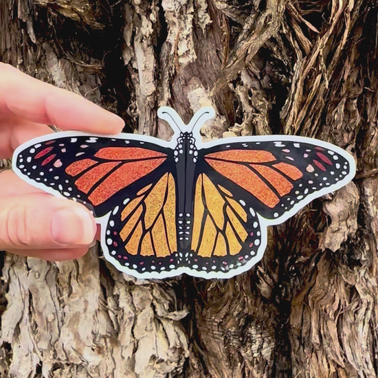 Monarch Butterfly Sticker movement video that shows the light reflecting on the artwork and glitter. 